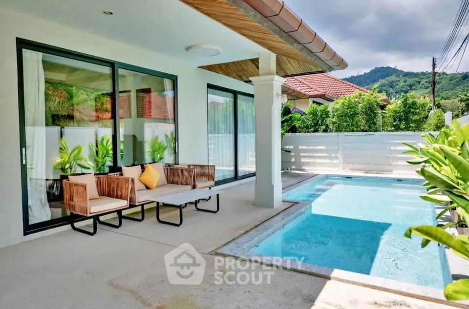 Stunning modern patio with pool and mountain view, perfect for relaxation and entertaining.