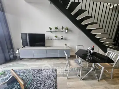 Modern living room with sleek staircase and stylish dining area