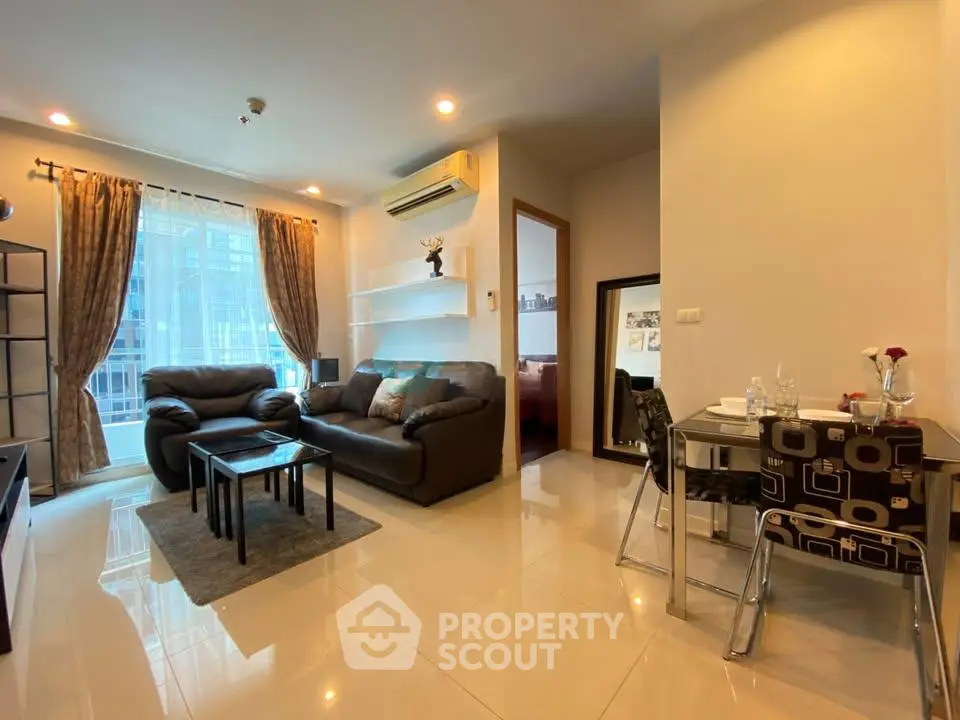 Modern living room with cozy seating and dining area in a stylish apartment.