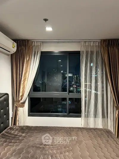 Luxurious bedroom with city view and elegant curtains