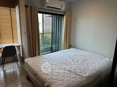 Cozy bedroom with balcony access and natural light, featuring modern air conditioning and stylish wooden blinds.