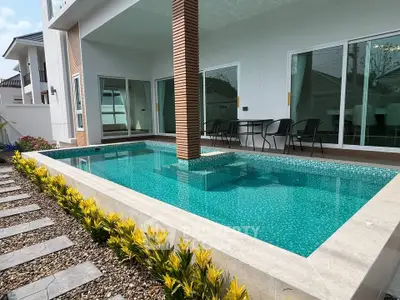 Luxurious modern home with private pool and stylish outdoor seating area, perfect for relaxation and entertainment.