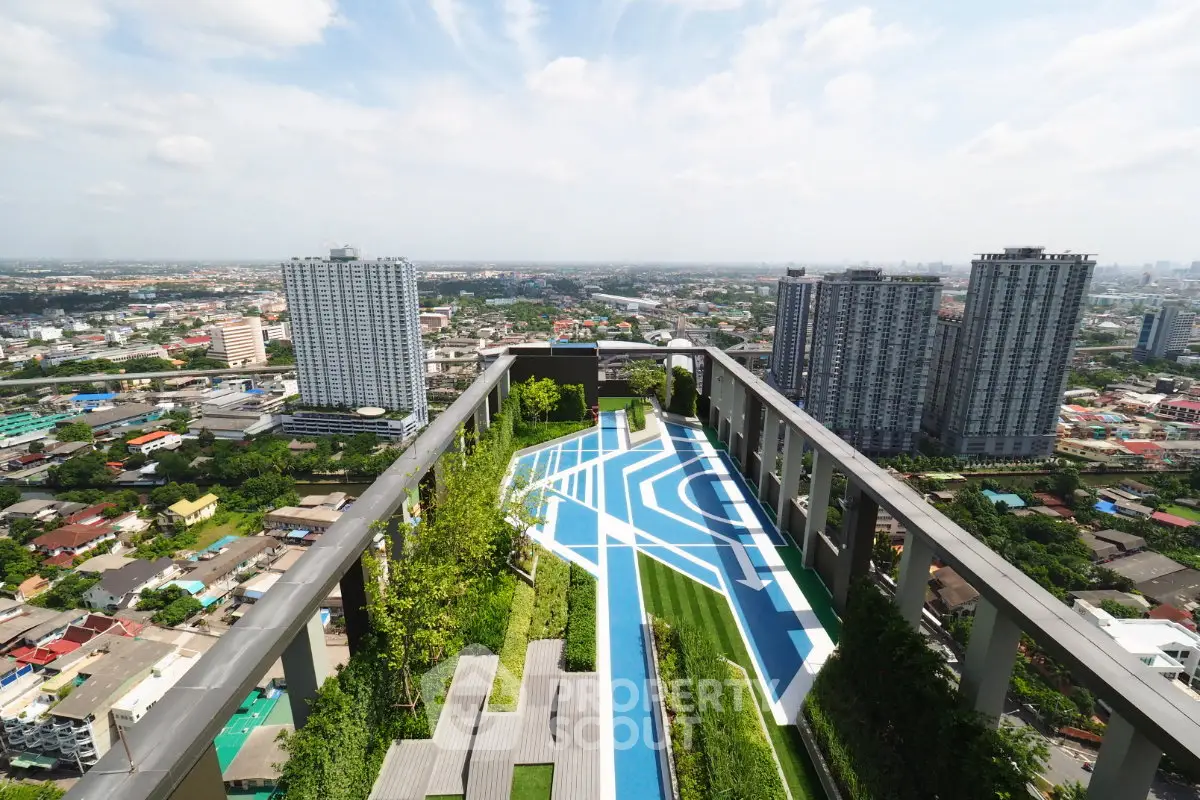 Stunning rooftop view with modern pool and lush greenery in urban high-rise setting.