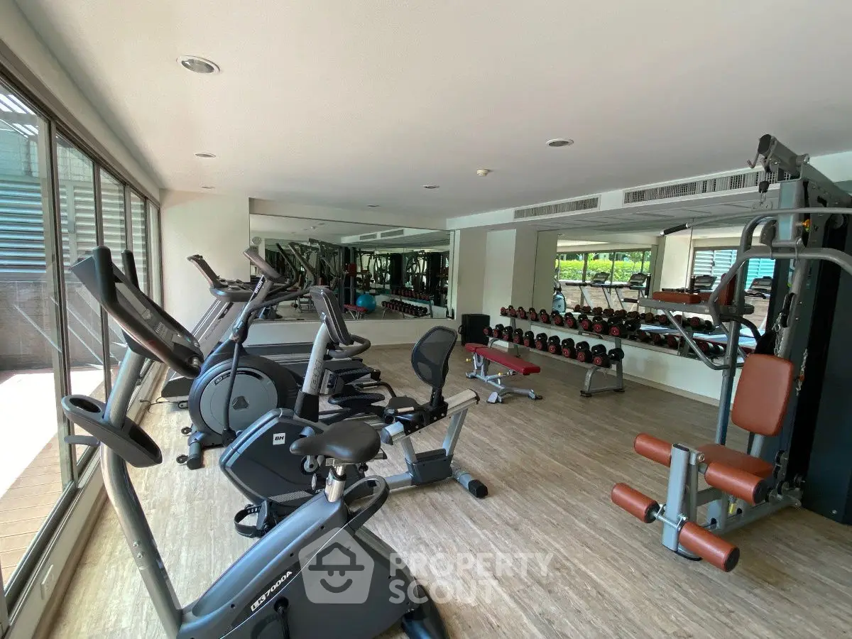 Spacious modern gym with state-of-the-art equipment and mirrored walls.