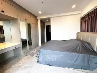 Spacious modern bedroom with sleek design and ample storage in luxury apartment.
