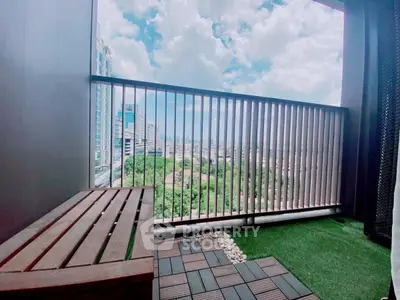 Charming balcony with stunning city view and cozy seating area.