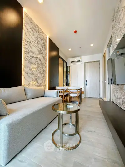 Modern living room with elegant marble accents and stylish furniture in a contemporary apartment.