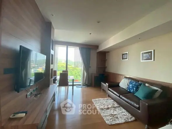 Spacious living room with modern decor and large window offering scenic views.