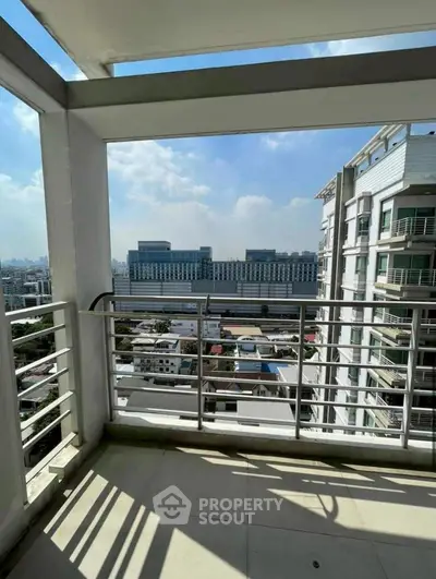 Spacious balcony with stunning city view in modern high-rise building.
