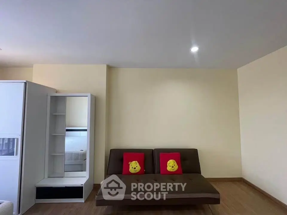 Modern living room with minimalist design and cozy sofa in a stylish apartment.