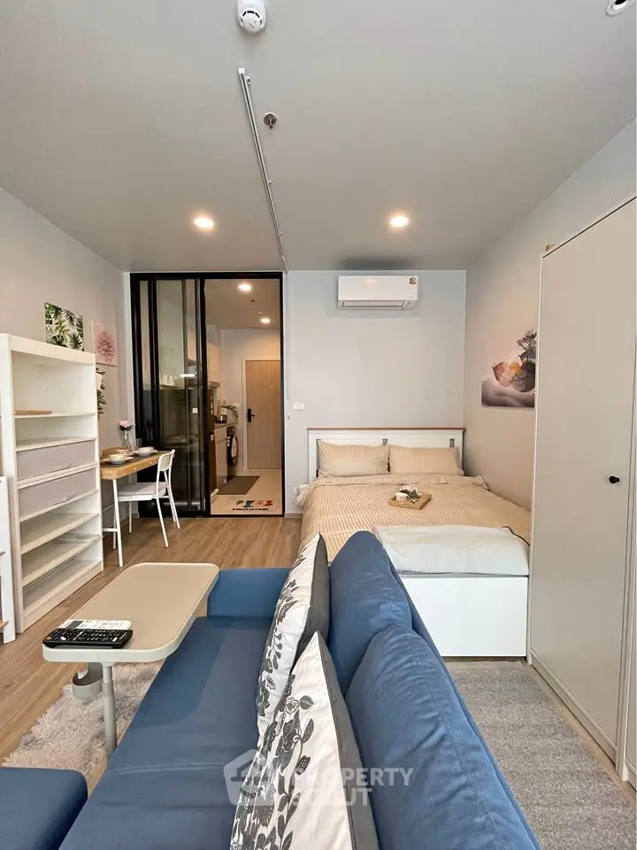 Modern studio apartment with cozy living area and stylish decor
