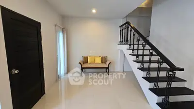 Modern minimalist interior with stylish staircase and cozy seating area