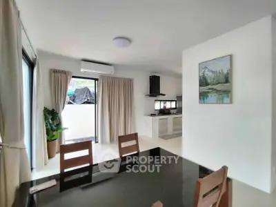 Modern dining area with open layout kitchen and natural light