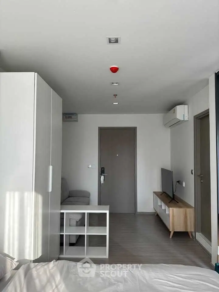 Modern studio apartment with sleek furniture and air conditioning