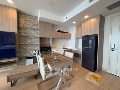 Modern open-layout kitchen and dining area with sleek appliances and stylish decor