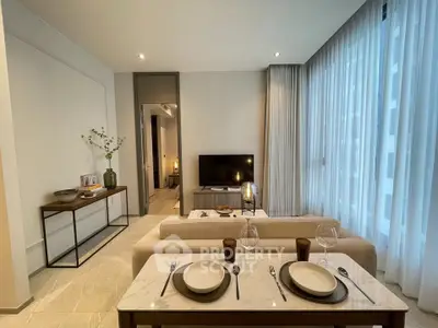 Modern living room with elegant dining setup and large windows in a stylish apartment.
