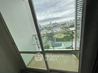 Stunning high-rise balcony view with cityscape and greenery, perfect for urban living.