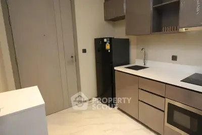 Modern kitchen with sleek cabinetry and built-in appliances in a contemporary apartment.