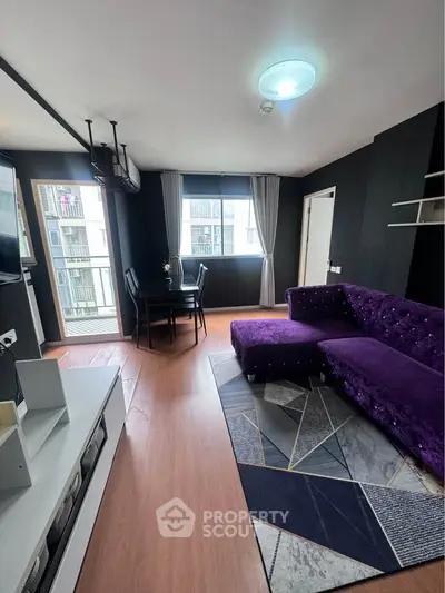 Modern living room with purple velvet sofa and dining area, featuring stylish decor and ample natural light.