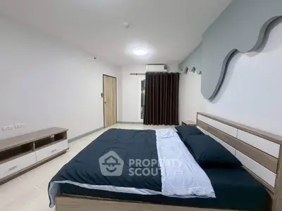 Modern bedroom with stylish decor and comfortable bedding in a contemporary apartment.