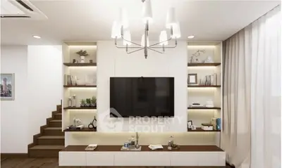 Modern living room with elegant lighting and built-in shelving around a flat-screen TV.