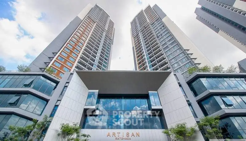 Stunning modern high-rise building with sleek architecture and glass facade reflecting the sky.