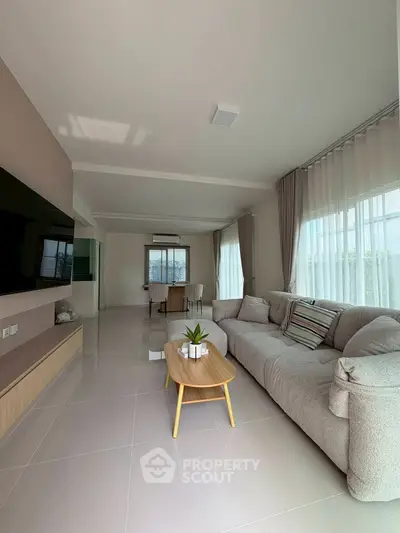 Spacious living room with modern decor and large windows for natural light.