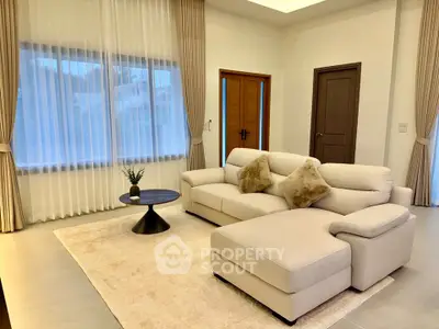 Spacious modern living room with elegant decor and cozy seating area.