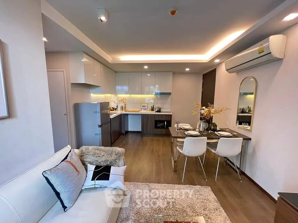 Modern open-plan living room and kitchen with stylish decor and dining area.