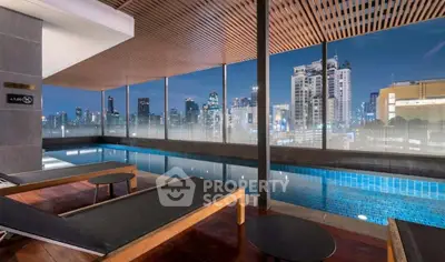 Luxurious rooftop pool with stunning city skyline view at night