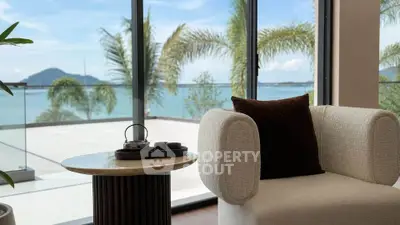 Luxurious living room with ocean view and elegant furniture, perfect for relaxation.