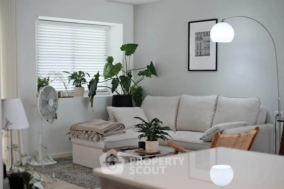 Stylish living room with cozy sofa, modern decor, and lush indoor plants