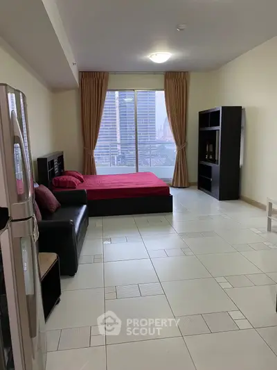 Spacious studio apartment with city view, modern furnishings, and large windows for natural light.