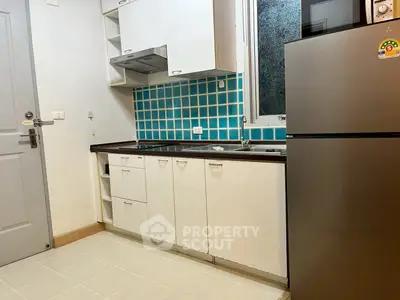 Modern kitchen with sleek cabinets and stainless steel fridge