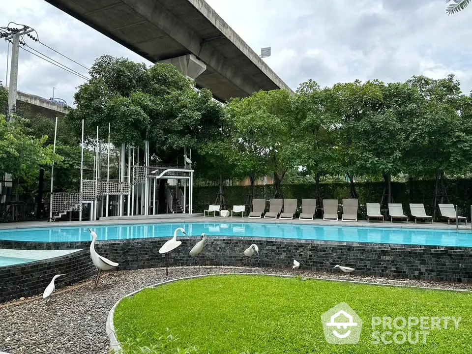 Luxurious outdoor pool area with modern design and lush greenery, perfect for relaxation and leisure.