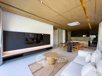 Luxurious modern living room with open kitchen, stylish furniture, and elegant wood ceiling design.
