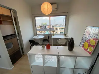 Charming study nook with city view, modern decor, and ample natural light for a cozy workspace.