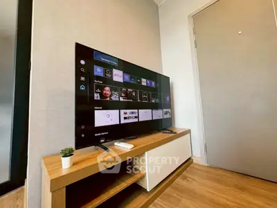 Modern living room with sleek TV setup and stylish wooden furniture