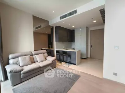 Modern living room with open kitchen layout and stylish furniture in a contemporary apartment.