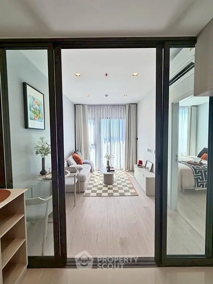 Modern living room with sliding glass doors and stylish decor in a contemporary apartment.