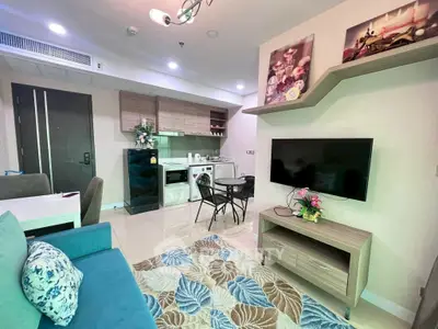 Modern open-layout living room with stylish kitchen and cozy decor