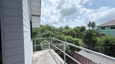 Charming balcony with lush green view in serene neighborhood
