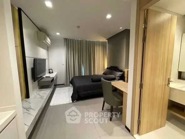 Modern studio apartment with sleek design, featuring a cozy bedroom and stylish living area.
