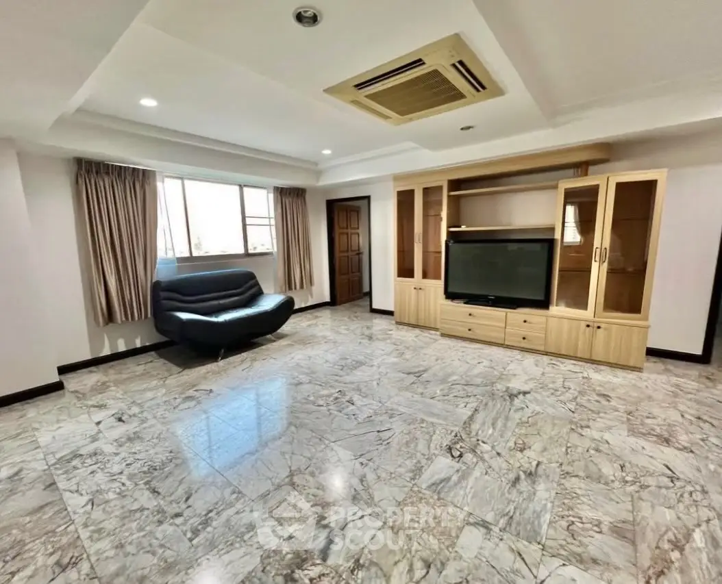 Spacious living room with marble flooring and built-in entertainment unit