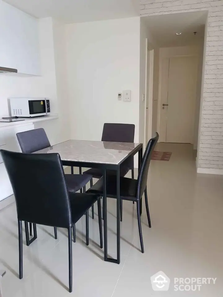 Modern dining area with sleek table and chairs in minimalist apartment