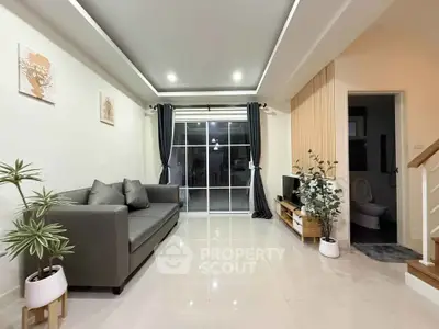 Modern living room with sleek sofa, stylish decor, and bright lighting in a contemporary home.
