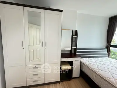 Modern bedroom with sleek wardrobe and comfortable bed in bright apartment