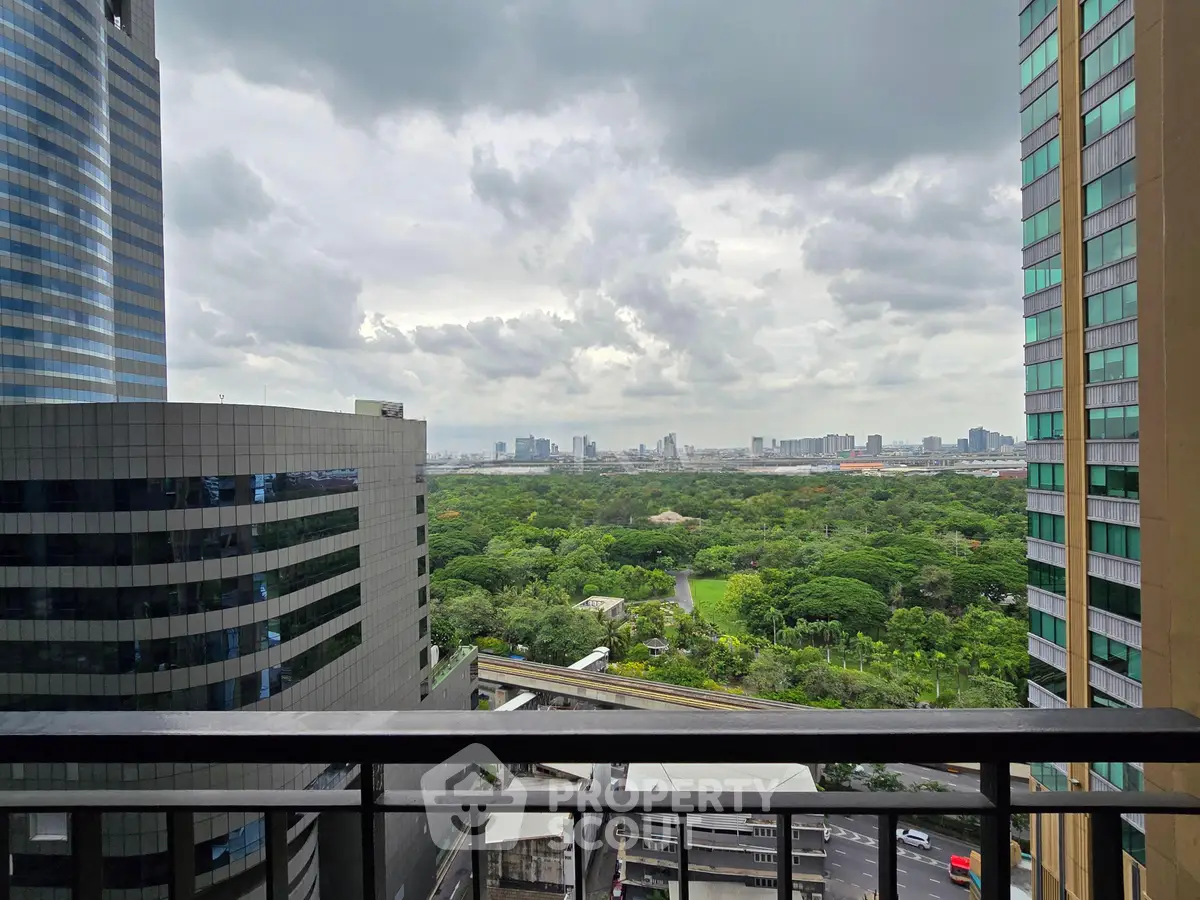 Stunning cityscape view from high-rise balcony overlooking lush greenery and modern skyscrapers.