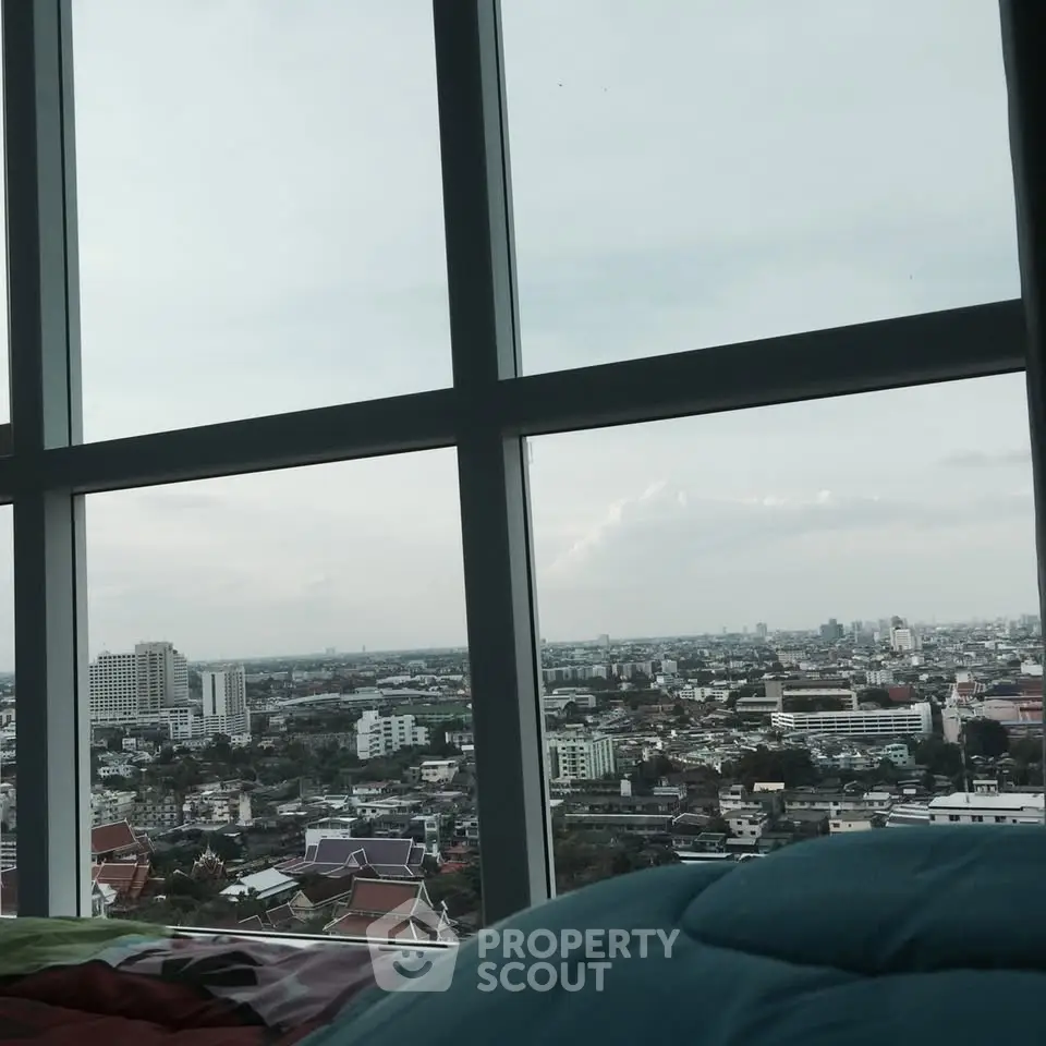 Stunning cityscape view from a high-rise apartment window, showcasing urban skyline and expansive horizon.
