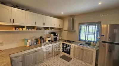 Modern kitchen with gas stove and ample storage in stylish home
